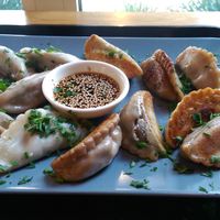 Half steamed/half fried Broccoli-Shitake-Tofu and Mushroom-Potato dumplings with Soy-Sesame dip. at Momos - Organic Veggie Dumplings in Berlin