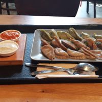 Large menu with lemon and tomato sauce at Momos - Organic Veggie Dumplings in Berlin