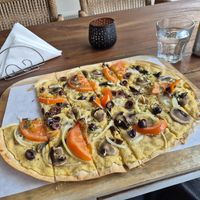 Vegan Flammkuchen with hummus, olives, tomatoes and Champignons at Lisa's Flammhouse in Larnaca