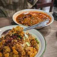 Nasi lemak (front) and assam pedas (back) at Normah's in West London