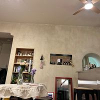 Interior with a small store (soy sauce, teriyaki sauce, and black garlic) and books (shelf on the left). at Plantastic Kitchen in Tbilisi