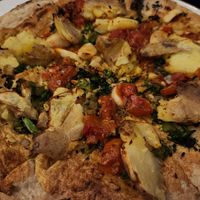 Vegan broccolini and potato pizza (cauliflower crust, cashew cheese, toppings - roasted broccolini, crushed potato, calabrian chilies, tomato, and rosemary) at Sixty Vines in Plano