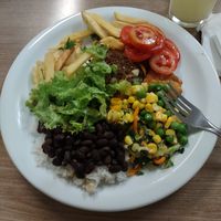 Tomatoes, green salad, french fries, green peas and corn. at Clube do Comércio Restaurante Porto Alegre in Porto Alegre
