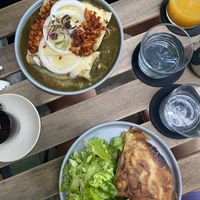 Enchiladas bañadas en salsa verde, fresh mango juice, and tortilla española   at Alguito Vegano in Mexico City