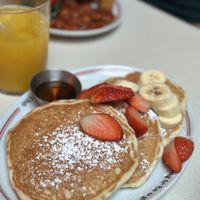 Pancakes with sirop strawberries and bananas   at The Breakfast Club in Chelmsford