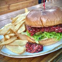 House made veggie burger(beets, red onion, broccoli, carrots, bell pepper, spinach, mushrooms, garlic), mixed greens, tomato and pickles  at Basecamp Dinette in Burbank