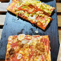 Pizza with fake mozzarella peppers onions and the other one with fake tuna and onions. Good! at Santoni - When food is the solution in Barcelona