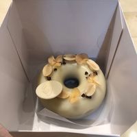 My very expensive donut! (Chocolate and peanut flavour with a white chocolate glaze).  at Angel Cakes - Yas Mall in Abu Dhabi