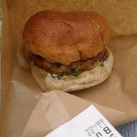 Burger with chili and spinach toppings at Veggie Junkies Burger in Kobe