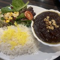 Fesenjan stew with saffron rice and salad  at Herby Restaurant in Toronto