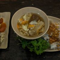 Steam big noodles that you dip in a sort of hot vinegar sauce, very very good. On the right, the brochette has a good texture. at Chay Vỉa Hè in Hanoi