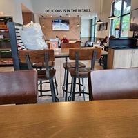 Dining area and wall motto at Urbane Cafe in Santa Clarita
