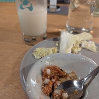 Makgeolli with complimentary jigemi/ deonjang mixture dip with cabbage. delicious both on their own right and a very nice pairing. at Ggulggeok House - 꿀꺽하우스 in Busan