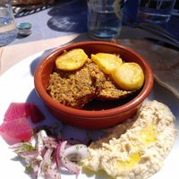 Homemade vegan patties with hummus and potatoes at Entre Terres Restaurant in Girona