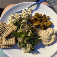 Plate made up of items purchased at the market - vegan Mac salad, chard salad, hummus, crackers, and a tofu red curry   at Briar Patch Co-op Community Market in Grass Valley