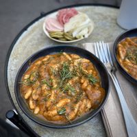 Cavatelli with pomodoro sauce and assorted pickled veggies in the background    at Unwind in Portland