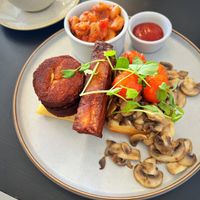 Vegan breakfast with lentil cakes and hash brown on a vegan waffle. Oat milk flat white and fresh juices  at Bar Hashery in York