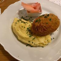 Ground seitan schnitzel filled with vegan cheese at Moment in Prague