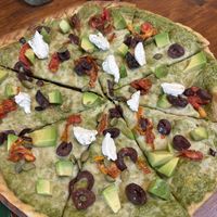 Vegan pesto pizza with vegan cheese and vegan feta on it   at Greenr Cafe  in Panaji
