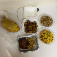 Left: vegan ground meat patty
Top center: plaintain fries
Bottom Center: eggplant Parm w/ garlic bread
Right Top: Bean salad
Right bottom: mango salad  at Love Thyself Vegan Kitchen in St Georges