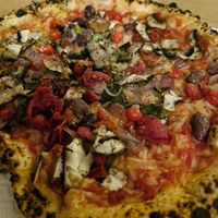 Tomato pizza, vegan cheese, mushrooms, onions, cherry tomatoes, chillis, cherry tomatoes. Delicious. at Rudy's Pizza Napoletana - Castle St in Liverpool