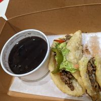 2 impossible taco plate with double black beans and two bites out of it. at Taco Cantina in San Francisco