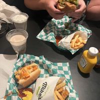 Too eager to start forgot to take picks first! Buffalo chicken sandwich and Colombiana hot dog with fries and milkshakes. Delicious!  at Mike's Vegan Grill in Charlotte