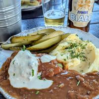 Soya cutlets with mashed potato and pickled cucumbers and Zero Alcohol white beer at Vegan Friends Kitchen in Warsaw