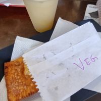 Savory pastel with caldo de cana (sugarcane juice) at Pastelaria da Barra in Santa Catarina