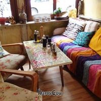 Inside the main dining area there is this cozy little sofa and chairs. Beautiful art on the walls, and delicious food and desserts. at Made In Home in Sofia