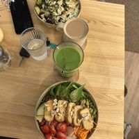 Tofu bowl (below) monthly root veggies bowl, acorn coffee and mango smoothie 💚  at Daržo Dubuo in Vilnius