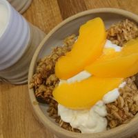 Baked oats with vegan yoghurt and peaches and a London Fog with oat milk at Five Acres in St Andrews