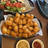 Chili topped dog with plain tots and dipping sauces   at Happy Dog - Detroit Ave in Cleveland