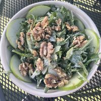 Arugula salad with walnuts, crisp green apples and an apple cider vinegar dressing. Just ask for no cheese to make it vegan .  at Lucky Penny in Santa Barbara