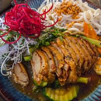 Mỳ Cay - udon noodles with vegetables and pak choi with chili sauce and vegan crispy duck at Koko Organic in Prague