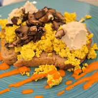 Scrambled Tofu with mushrooms and vegan Feta cheese on whole wheat toast at Nourish Wellness Cafe - Pop Life  in Cleveland