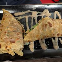 "Rolex" roll, a flat bread with lots of filling rolled up and grilled with peanut sauce on top at Shani's African Snacks in Hamburg