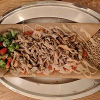 Ingoodie tibs - injera bread covered with a tomato sauce and mushrooms at Tenat in Tel Aviv