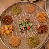 Bayanetu (double dish) - injera bread with variety of spreads/salads at Tenat in Tel Aviv