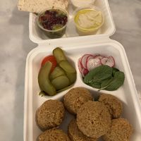 Jamal Falafel Middag Special - 7 huge homemade falafel, creamy hummus, smoky baba ganoush, tahini dressing, warm pita, pickles and fresh veggies   at Jamal's Falafel in Oslo