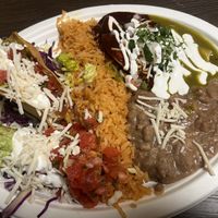 Combo plate #3 crispy potato taco, chicken taquito, enchilada green/red  at El Cantaro Vegan Mexican Restaurant in Monterey
