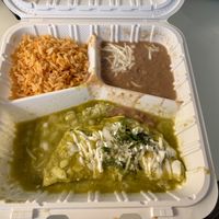 Spinach enchilada with my choice of green sauce, and pinto beans over black beans.   at El Cantaro Vegan Mexican Restaurant in Monterey