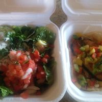 Salad: Spring mixed lettuce with corn, tomatoes, cheese, avocado, tortilla chips, cilantro and ranch jalapeño dressing. And tasty fish taco: vegan tuna with cabbage and mango sals at El Cantaro Vegan Mexican Restaurant in Monterey