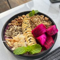 Dragonfruit smoothie breakfast bowl with nuts and granola at Copper Bonnet in 