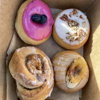 Blueberry sage, maple pecan, bananas foster, sweet potato cinnamon roll  at Cloudy Donut Co - NoLita in New York City