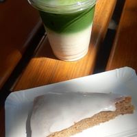 Iced matcha latte and vegan carrot cake to go at Aufzug Café in Vienna