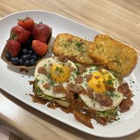 Avocado toast with sunny side up eggs, bacon and hashbrowns.   at A Lo Vegano in Orlando