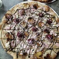 Pizza with pistachio cream, rose cream, courgette chips, hazelnut balls, black salt at Opera 140 - Maybe closed in Genoa