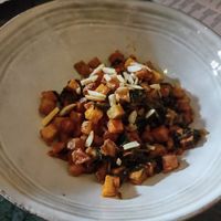 Fries with lemon juice, almonds, cilantro, and garlic at Fatouch in Sevilla