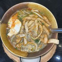 Sukothai tom yum noodles with plant-based pork, meatballs and eggs.  at Kem-Kon Pahurat (เข้ม-ข้น พาหุรัด) in Bangkok